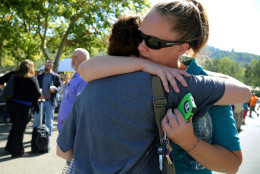 A woman is comforted as friends and family wait for students at the local fairgrounds after a shooting at Umpqua Community College in Roseburg, Ore., on Thursday, Oct. 1, 2015.   (AP Photo/Ryan Kang)