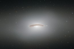This image made by the NASA/ESA Hubble Space Telescope shows NGC 4526. One of the brightest lenticular galaxies known, it has hosted two known supernova explosions, one in 1969 and another in 1994, and is known to have a supermassive black hole at its center with a mass of 450 million Suns. NGC 4526 is part of the Virgo cluster of galaxies. A version of this image was entered into the Hubble's Hidden Treasures image processing competition by contestant Judy Schmidt during an initiative to invite astronomy enthusiasts to search the Hubble archive for notable images that have never been seen by the general public. The Hubble Space Telescope marks its 25th anniversary. A full decade in the making, Hubble rocketed into orbit on April 24, 1990, aboard space shuttle Discovery.  (ESA/Hubble &amp; NASA via AP)