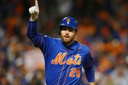 New York Mets' Daniel Murphy celebrates his home during the first inning of Game 1 of the National League baseball championship series against the Chicago Cubs Saturday, Oct. 17, 2015, in New York. (AP Photo/Elsa Garrison, Pool)
