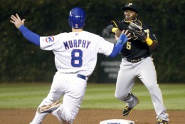 Pittsburgh Pirates second baseman Josh Harrison (5) turns the double play forcing Chicago Cubs' Donnie Murphy (8) at second and getting Brian Bogusevic at first during the second inning of a baseball game Tuesday, Sept. 24, 2013, in Chicago. (AP Photo/Charles Rex Arbogast)