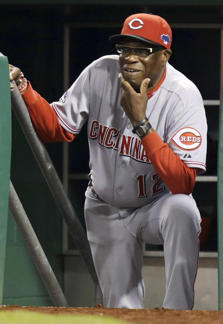 Cincinnati Reds manager Dusty Baker watches from the dugout steps as the Pittsburgh Pirates bat in the fifth inning of the NL wild-card playoff baseball game Tuesday, Oct. 1, 2013, in Pittsburgh. (AP Photo/Gene J. Puskar)
