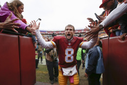 Washington Redskins quarterback Kirk Cousins (8) celebrates with fans as he leaves the field after an NFL football game against the Philadelphia Eagles in Landover, Md., Sunday, Oct. 4, 2015. The Redskins defeated the Eagles 23-20. (AP Photo/Alex Brandon)