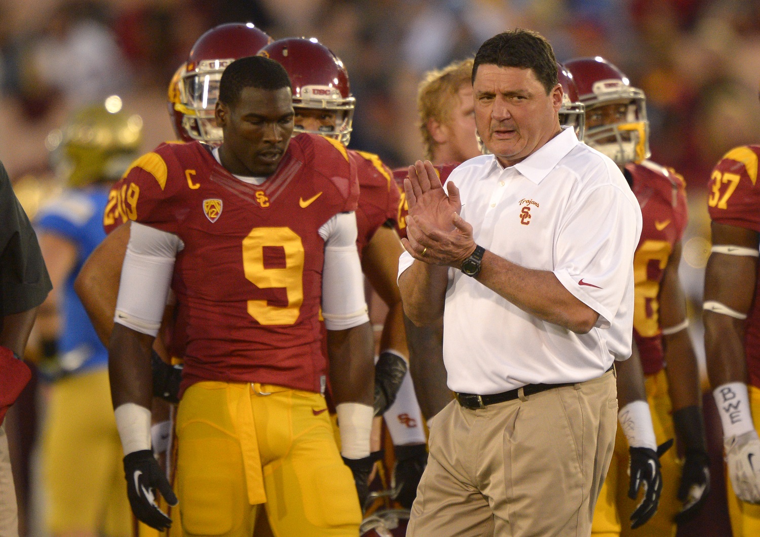 Southern California interim head coach Ed Orgeron, right, cheers on his team as wide receiver Marqise Lee, left, looks on during warmups prior to an NCAA college football game against UCLA, Saturday, Nov. 30, 2013, in Los Angeles. (AP Photo/Mark J. Terrill)