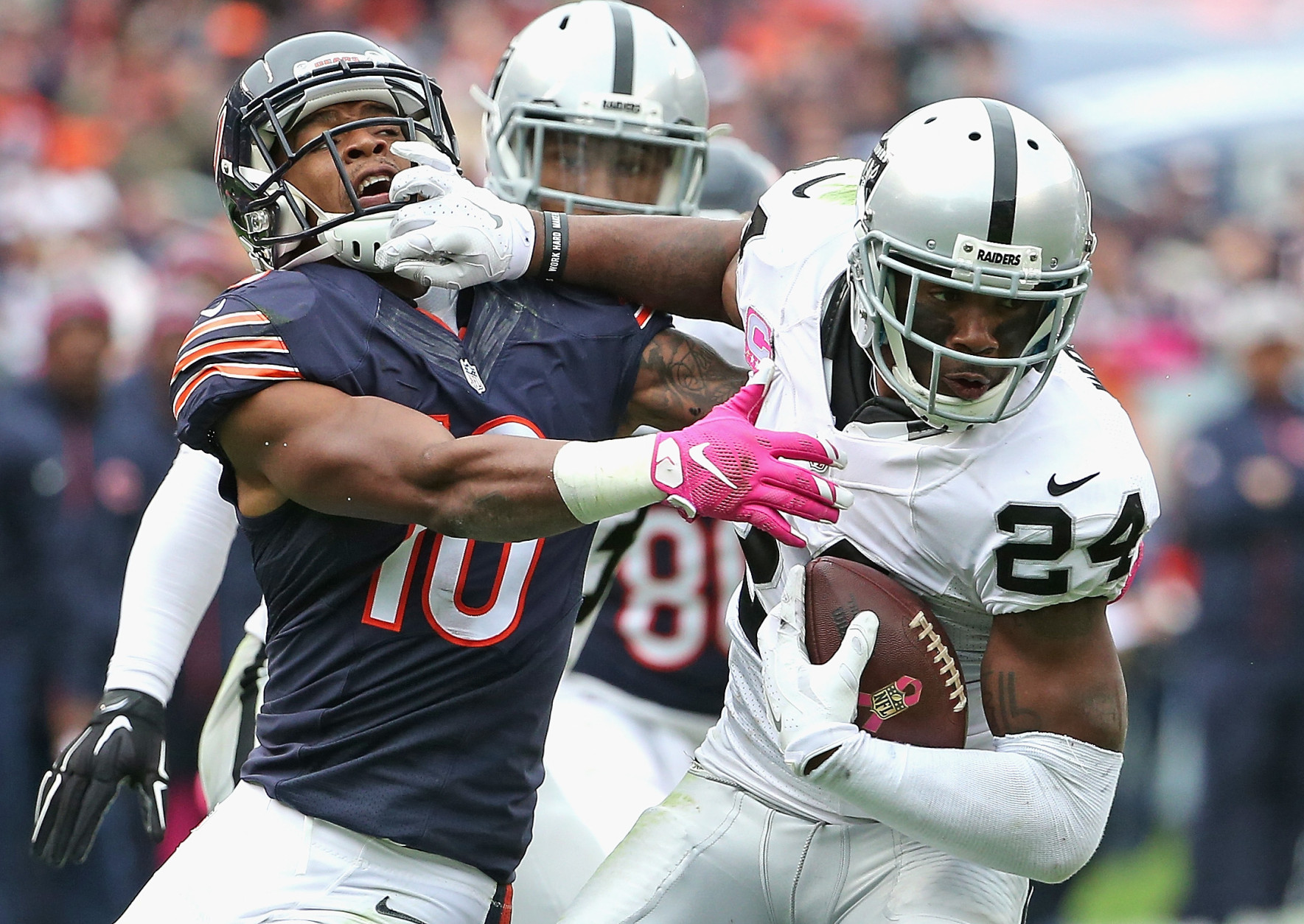 CHICAGO, IL - OCTOBER 04: Charles Woodson #24 of the Oakland Raiders breaks way from Marquess Wilson #10 of the Chicago Bears after intercepting a pass in the 4th quarter at Soldier Field on October 4, 2015 in Chicago, Illinois. The Bears defeated the Raiders 22-20. (Photo by Jonathan Daniel/Getty Images)