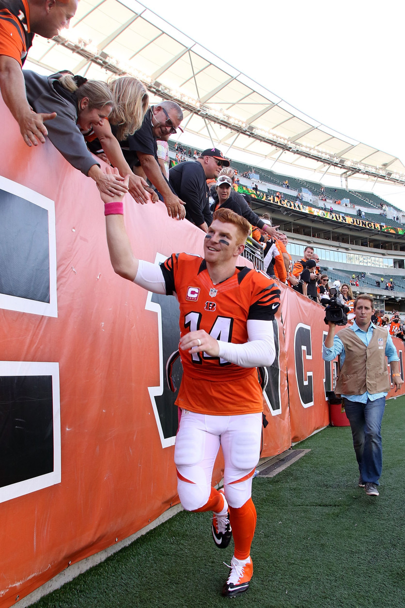 CINCINNATI, OH - OCTOBER 4:  Andy Dalton #14 of the Cincinnati Bengals shakes hands with fans while running off of the field after defeating the Kansas City Chiefs 36-21 at Paul Brown Stadium on October 4, 2015 in Cincinnati, Ohio. (Photo by John Grieshop/Getty Images)