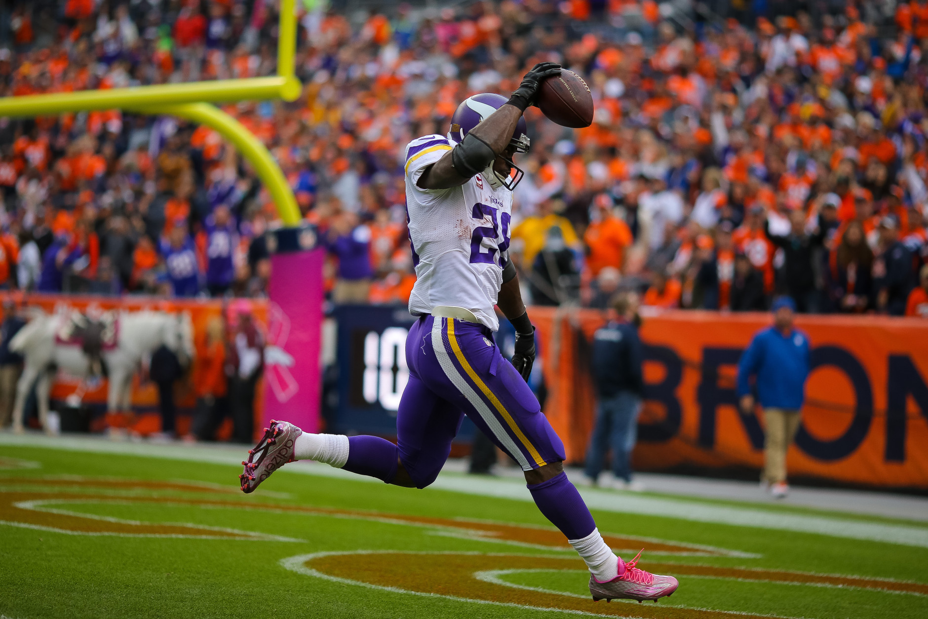 DENVER, CO - OCTOBER 4:  Running back Adrian Peterson #28 of the Minnesota Vikings celebrates after rushing for a 48 yard touchdown against the Denver Broncos in the fourth quarter of a game at Sports Authority Field at Mile High on October 4, 2015 in Denver, Colorado.  (Photo by Justin Edmonds/Getty Images)