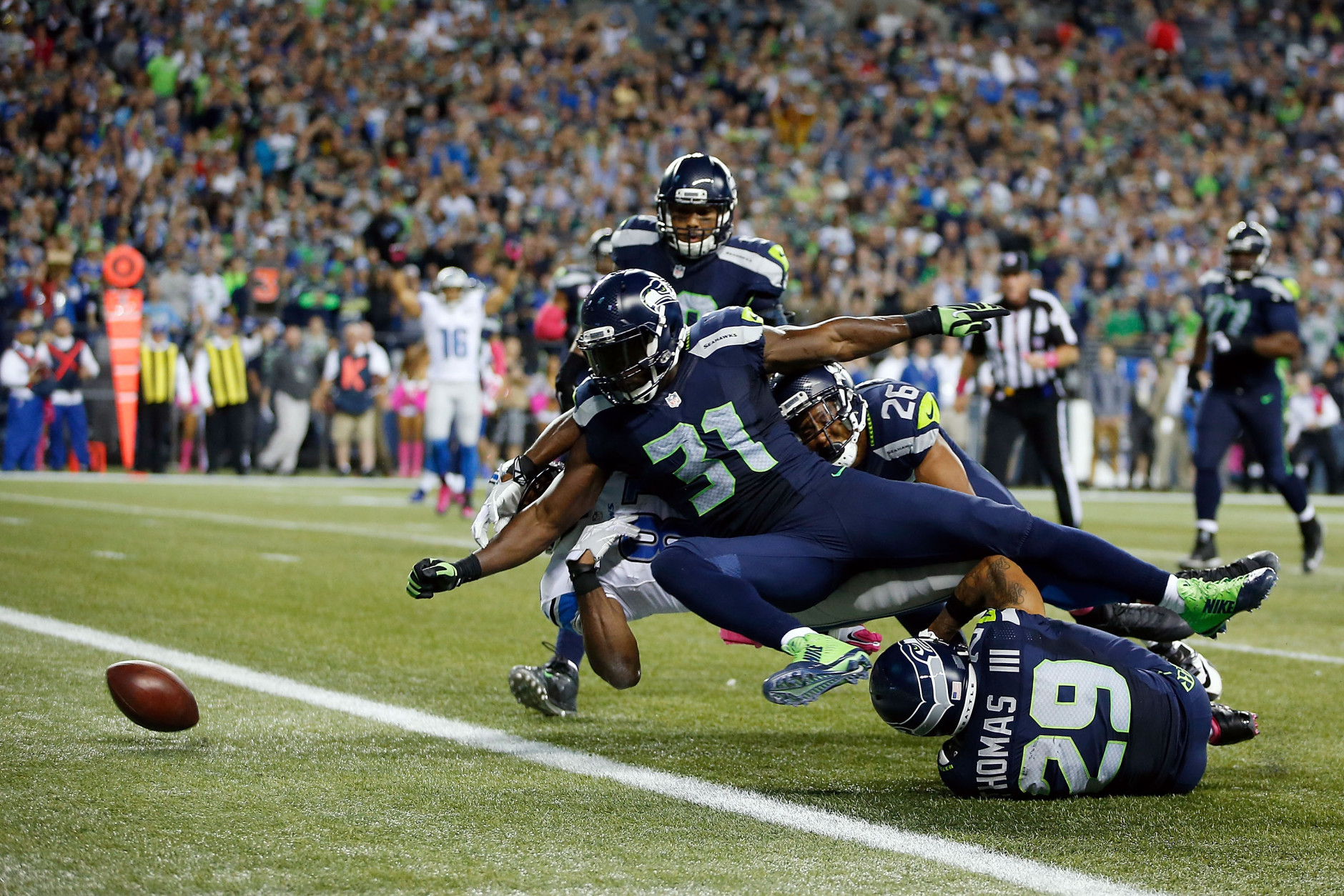 SEATTLE, WA - OCTOBER 05:  Kam Chancellor #31 of the Seattle Seahawks forces Calvin Johnson #81 of the Detroit Lions to fumble the ball near the goal line during the fourth quarter of their game at CenturyLink Field on October 5, 2015 in Seattle, Washington.  (Photo by Otto Greule Jr/Getty Images)