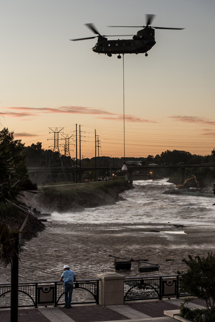 COLUMBIA, SC - OCTOBER 6:  A Chinook helicopter lowers a massive sandbag just up from the breach of the Columbia Canal October 6, 2015 in Columbia, South Carolina. The breach of the canal, caused by recent flooding, has left the City of Columbia without safe drinking water. (Photo by Sean Rayford/Getty Images)