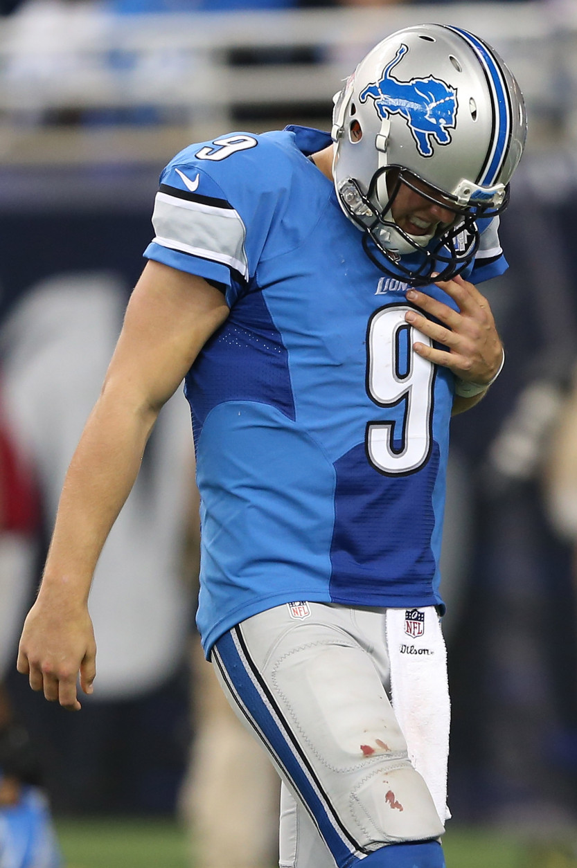 DETROIT MI - OCTOBER 11: Matthew Stafford of the Detroit Lions walks off the field holding his shoulder after being sacked by the Arizona Cardinals in the second quarter  on October 11, 2015 at Ford Field in Detroit, Michigan.  (Photo by Leon Halip/Getty Images)