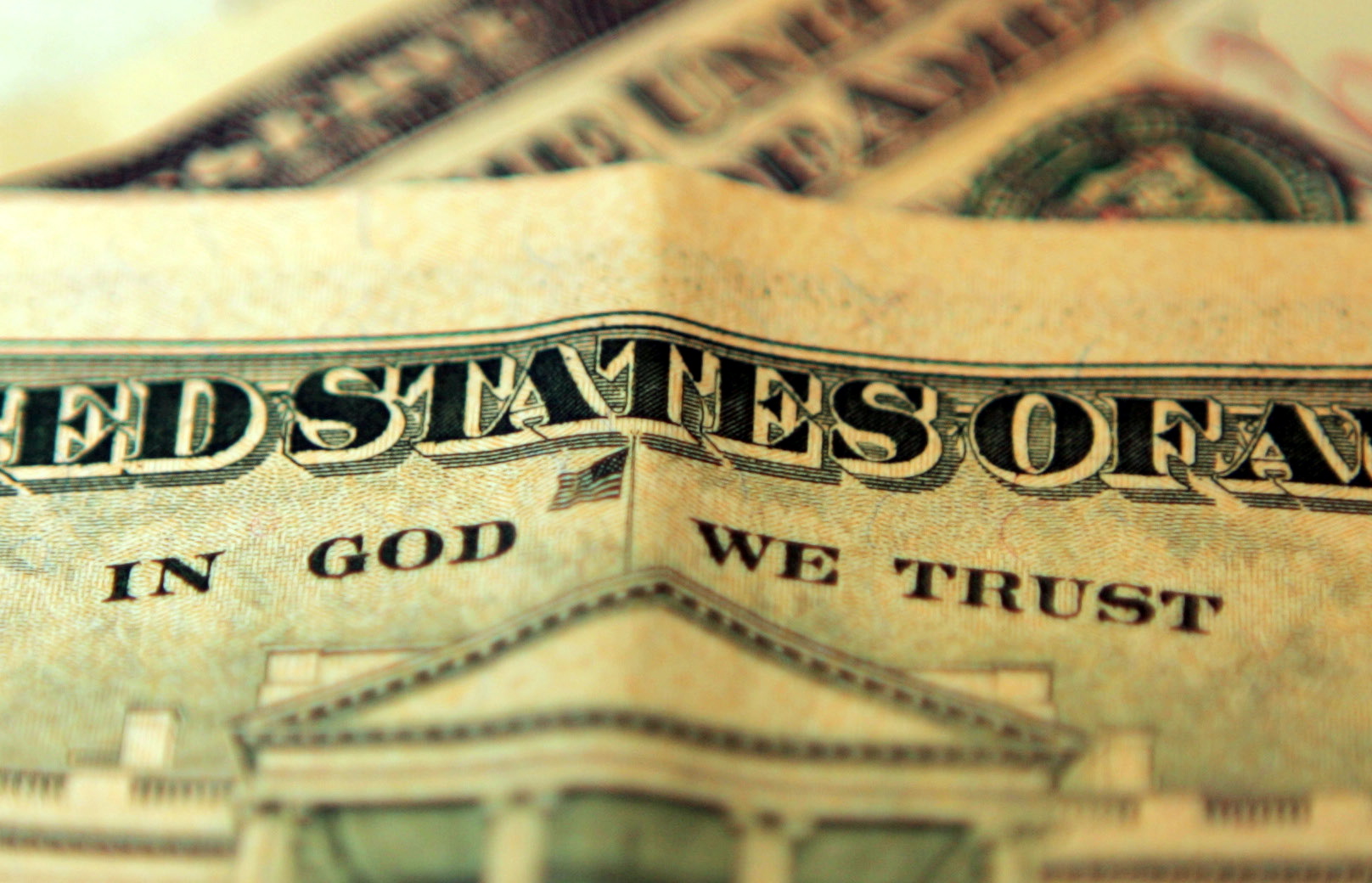 LONDON, UNITED KINGDOM - OCTOBER 23: In this photo illustration the phrase "In God We Trust"  can be seen on an American ten dollar bill on October 23, 2008 in London, England. The British pound has hit it's lowest point against the Dollar in five years as it fell to just above 1.62 US Dollars after fears of a recession were acknowledged by the government and financial experts today.  (Photo by Hugh Pinney/Getty Images)