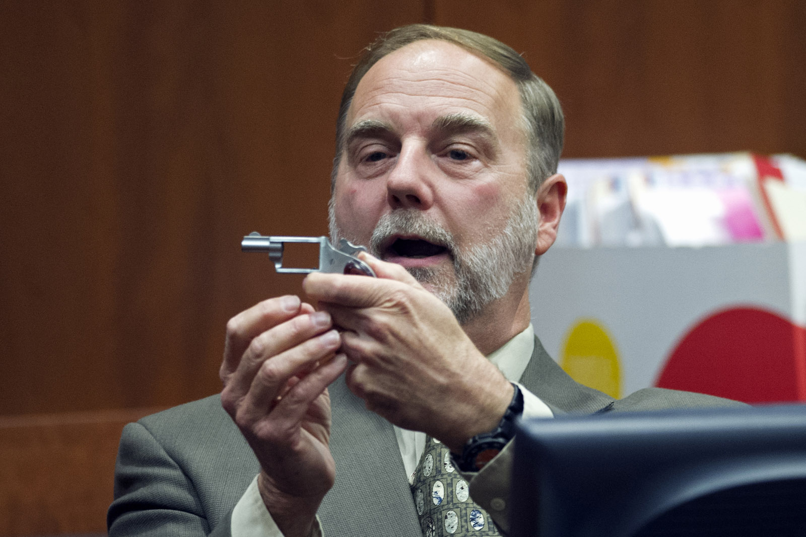 Julien J. Mason, Jr., forensic firearms and tool mark examiner, Virginia Department of Forensic Science, holds a North American Arms .22LR five-shot revolver while providing testimony in the Charles Severance trial, Tuesday, Oct. 20, 2015, at the Fairfax County Circuit County in Fairfax, Va. Severance is accused of three murders over the course of a decade in Alexandria, Va.  (AP Photo/Cliff Owen, Pool)