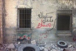 According to the artists, the graffiti at left reads "This show does not represent the views of the artists." The graffiti at top reads "We didn't resist, so he conquered us riding a donkey," while the bottom reads "The situation is not to be trusted." (Courtesy of the artists)