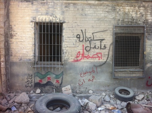 According to the artists, the graffiti at left reads "This show does not represent the views of the artists." The graffiti at top reads "We didn't resist, so he conquered us riding a donkey," while the bottom reads "The situation is not to be trusted." (Courtesy of the artists)