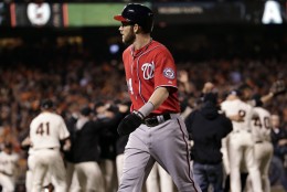 Washington Nationals right fielder Bryce Harper walks off the field after Game 4 of baseball's NL Division Series in San Francisco, Tuesday, Oct. 7, 2014. The Giants beat the Nationals 3-2 to advance to the next round. (AP Photo/Marcio Jose Sanchez)