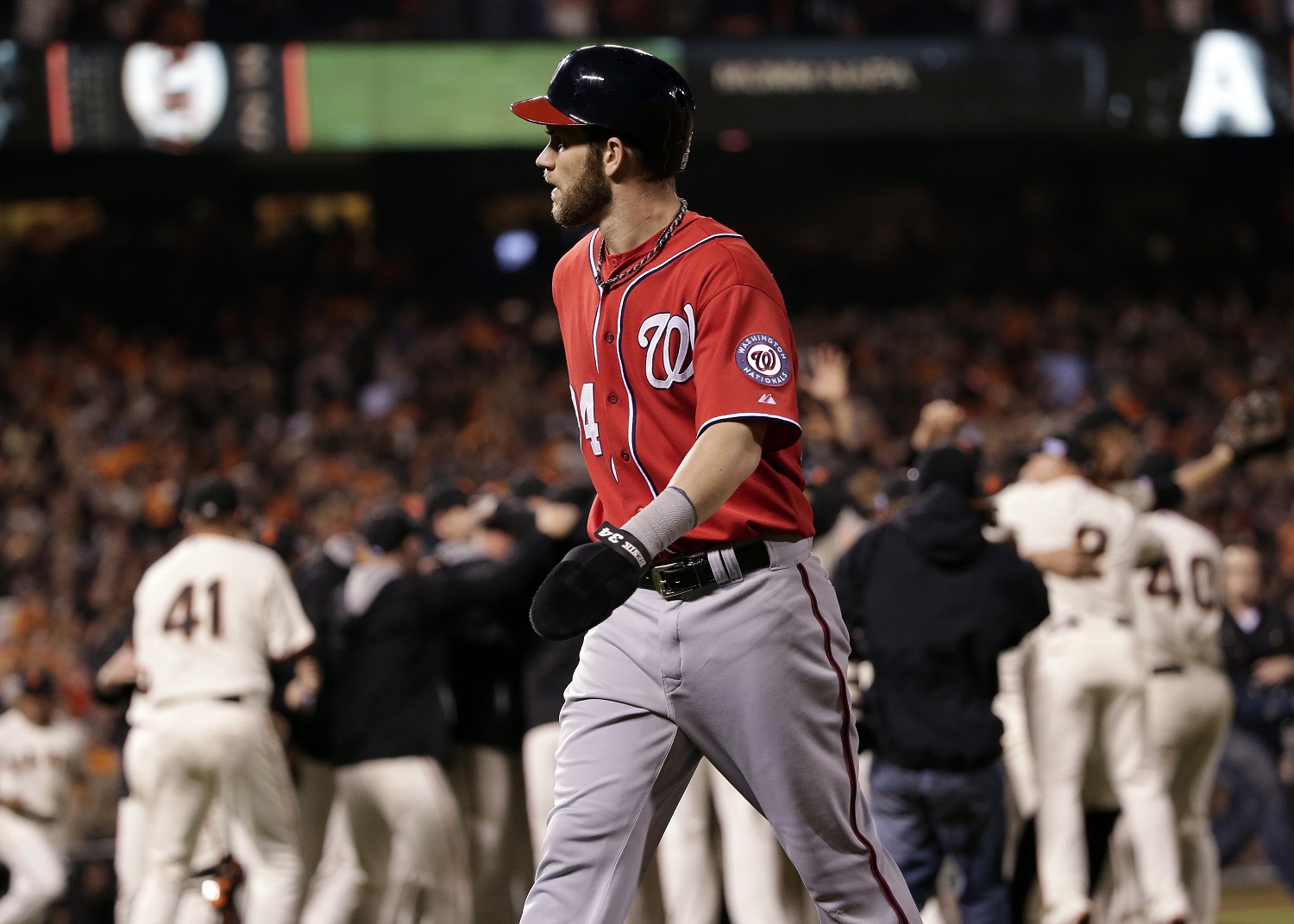 Washington Nationals right fielder Bryce Harper walks off the field after Game 4 of baseball's NL Division Series in San Francisco, Tuesday, Oct. 7, 2014. The Giants beat the Nationals 3-2 to advance to the next round. (AP Photo/Marcio Jose Sanchez)
