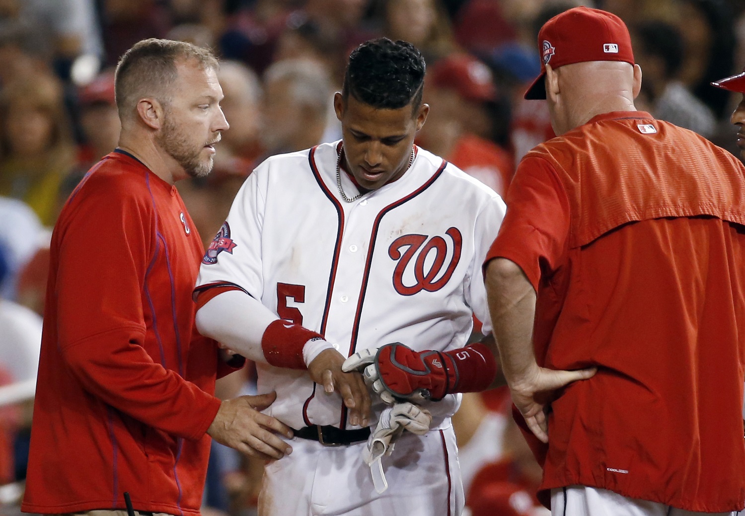 Washington Nationals' Yunel Escobar (5) points to his hand after he was hit by a pitch, as manager Matt Williams stands at right, during the fifth inning of a baseball game against the San Diego Padres at Nationals Park, Thursday, Aug. 27, 2015, in Washington. Escobar did not take the field for the next inning. (AP Photo/Alex Brandon)