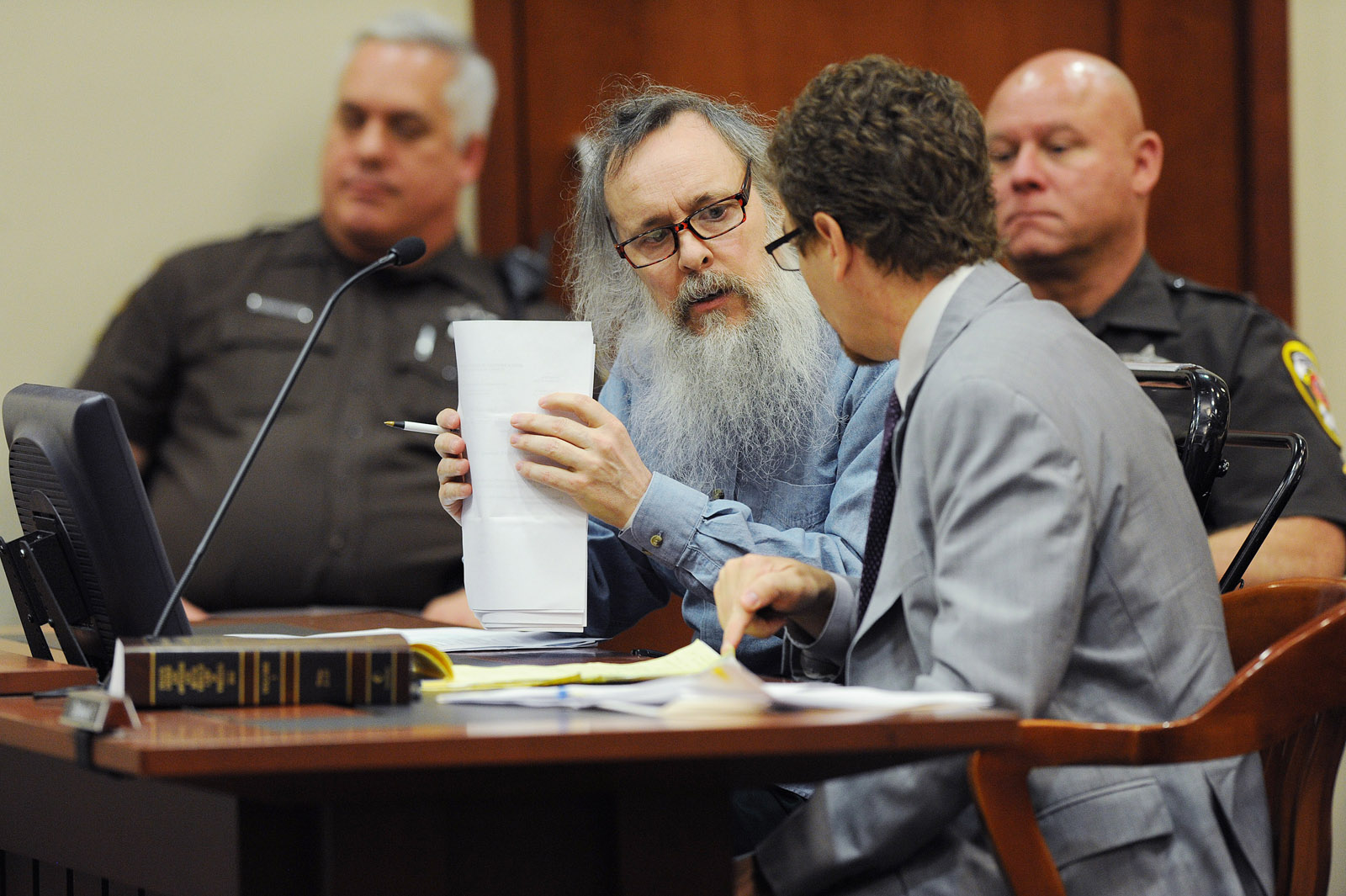 Charles Severance, center, talks to defense attorney, Joe King, right center, as he appears in Fairfax County Circuit Court on Thursday October 01, 2015 in Fairfax, Va. Severance is accused of three murders over the course of a decade in Alexandria, Va. (Pool Photo by Matt McClain/ The Washington Post)
