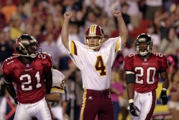 Washington Redskins kicker Michael Husted (4) celebrates after his winning field goal in overtime to beat the Tampa Bay Buccaneers 20-17, Sunday, Oct. 1, 2000, at FedEx Field in Landover, Md. Tampa Bay's Donnie Abraham (21) and Ronde Barber (20) look on.  (AP Photo/Nick Wass)