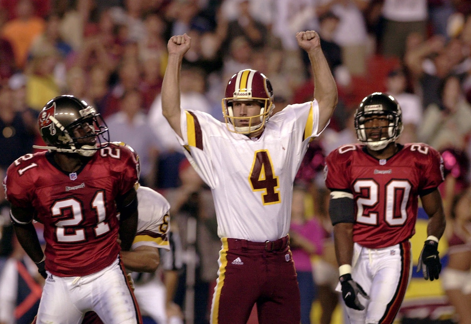 Washington Redskins kicker Michael Husted (4) celebrates after his winning field goal in overtime to beat the Tampa Bay Buccaneers 20-17, Sunday, Oct. 1, 2000, at FedEx Field in Landover, Md. Tampa Bay's Donnie Abraham (21) and Ronde Barber (20) look on.  (AP Photo/Nick Wass)