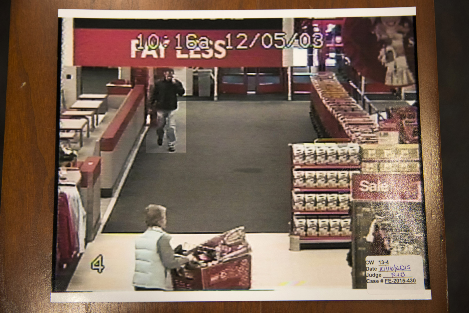A freeze frame from a surveillance video of Nancy Dunning, lower left, and a person of interest inside a Target store the day of Dunning's murder is photographed during the Charles Severance murder trial  at the Fairfax County Circuit Court in Fairfax, Va., Friday, Oct. 16, 2015.  Severance is accused of three murders over the course of a decade in Alexandria, Va. (AP Photo/Evan Vucci, Pool)