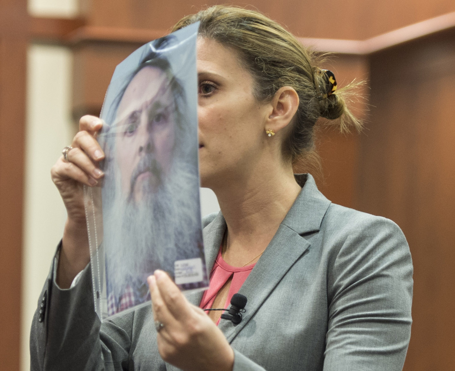 Defense attorney Megan Thomas holds up a photo of Charles Severance during closing arguments in his trial at the Fairfax County Circuit Court in Fairfax, Virginia, on Wednesday, October 28, 2015. (Pool Photo by Nikki Kahn/The Washington Post)