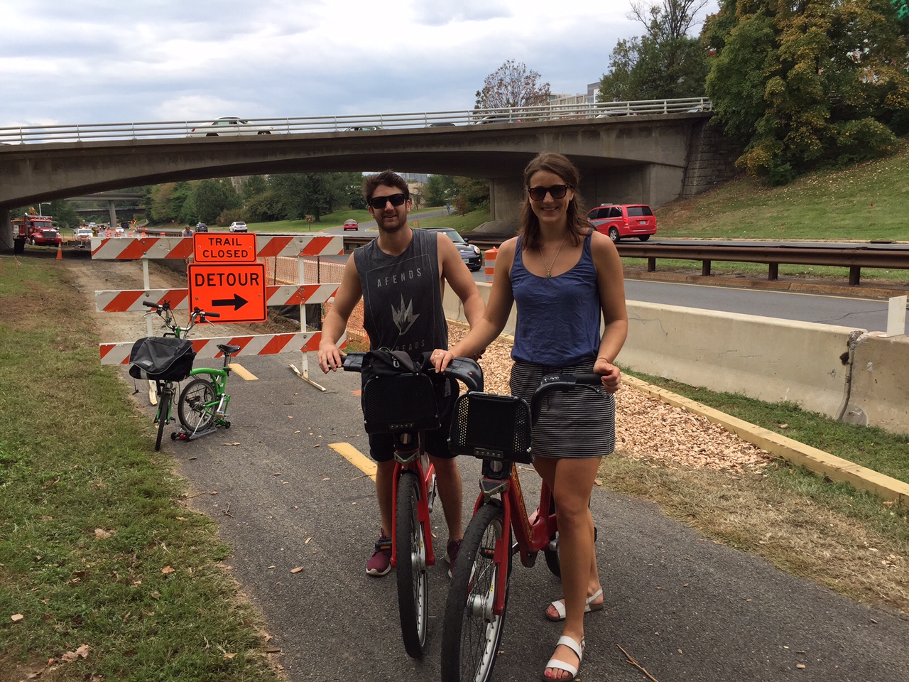Andrew Maclellan and Jessica Moulds, visitors from New Zealand, were riding Capital Bikeshare bikes along the trail, and weren't put off by the narrower mulch pathways in the work zones. "If this is the only problem you have -- a little bit of mulch -- I think you're doing pretty well to be honest," Maclellan said. (WTOP/Kate Ryan)