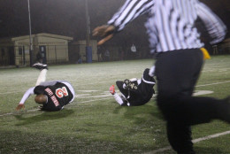 The referee runs to make the call on the play that caused both players to hit the ground. (WTOP/Dana Gooley)