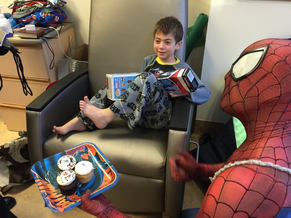 Jake says he wants out of the hospital, but enjoys the visit during this year's Hope For Henry Superhero Extravaganza. (WTOP/Kristi King) 