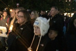 Family members held battery-powered candles with flickering bulbs. (WTOP/Dick Uliano)