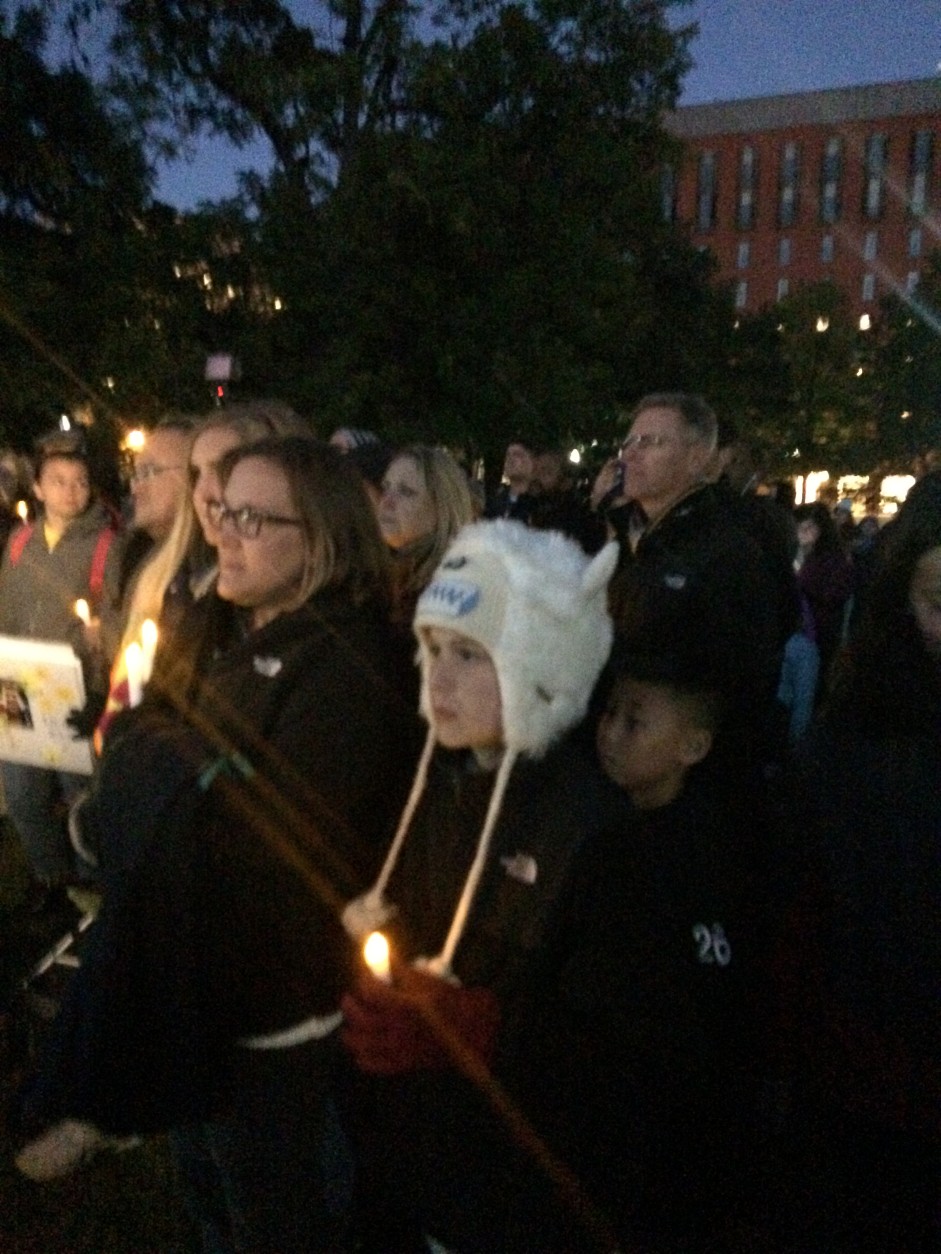 Family members held battery-powered candles with flickering bulbs. (WTOP/Dick Uliano)