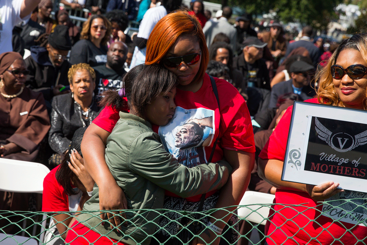 Margaret Holland, of Baltimore, Md., right, hugs her nine year-old daughter Jaylah Sabb during a rally to mark the 20th anniversary of the Million Man March, on Capitol Hill, on Saturday, Oct. 10, 2015, in Washington. (AP Photo/Evan Vucci)