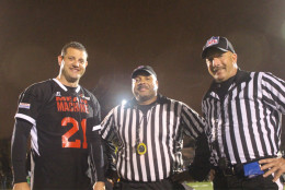 Mean Machine # 21 David Valadao, R-CA, poses with two referees. (WTOP/Dana Gooley)