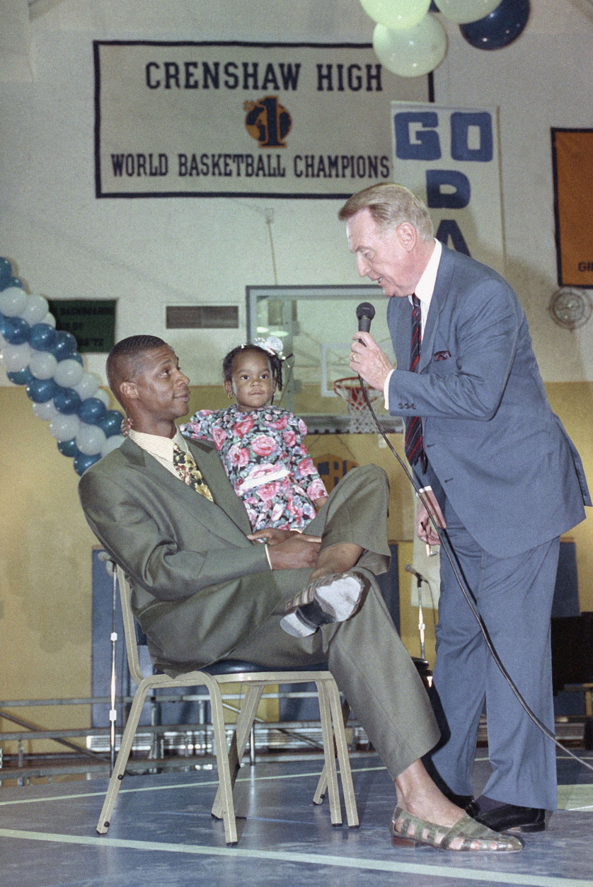 Darryl Strawberry, left, with daughter Diamond, 2 yrs., is greeted by Dodgers announcer and baseball Hall of Famer Vin Scully, Thursday, Feb. 14, 1991 in Los Angeles. Strawberry was on hand at Crenshaw High School, his alma mater, for a salute in his honor that welcomed him back to L.A. after signing a multimillion dollar contract with the Los Angeles Dodgers. (AP Photo/Julie Markes)