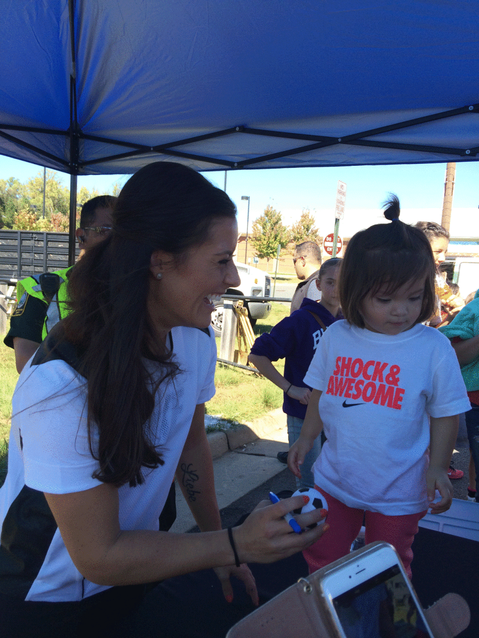Ali Krieger with one of her littlest fans. (WTOP/Dick Uliano)