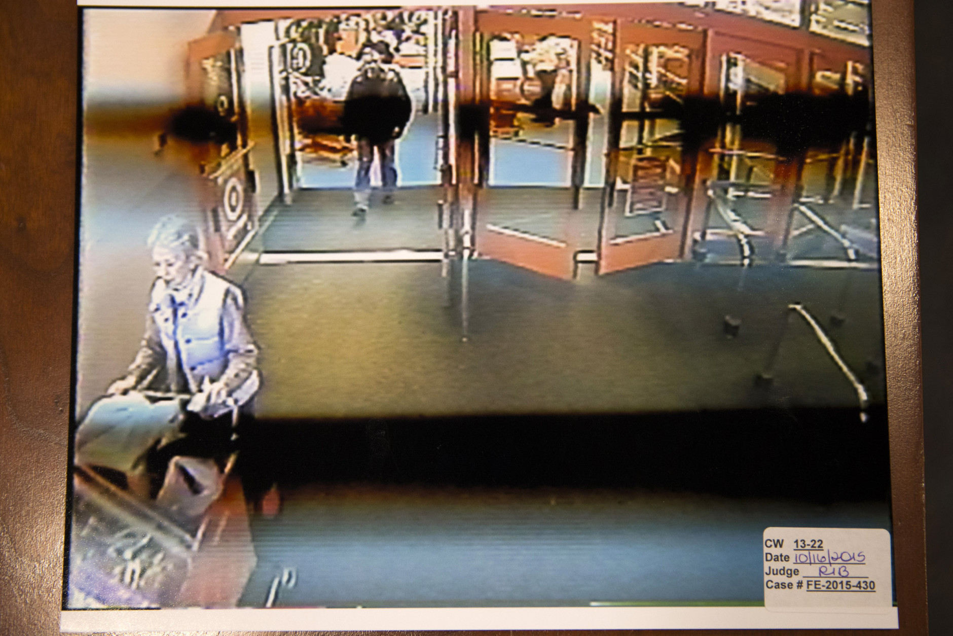 A freeze frame from a surveillance video of Nancy Dunning, lower left, and a person of interest inside a Target store the day of Dunning's murder is photographed during the Charles Severance murder trial at the Fairfax County Circuit Court in Fairfax, Va., Friday, Oct. 16, 2015.  Severance is accused of three murders over the course of a decade in Alexandria, Va. (AP Photo/Evan Vucci, Pool)