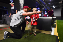 Colt McCoy gives advice to a young golfer whose family is associated with the TAPS organization. (Courtesy Washington Redskins)