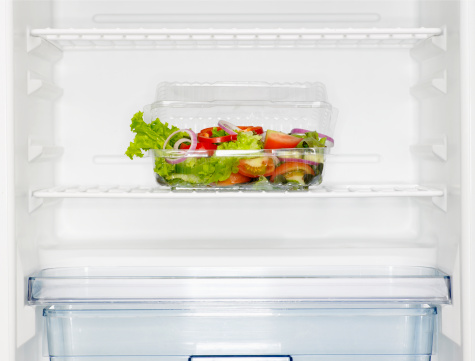 Salad box in fridge (close-up)