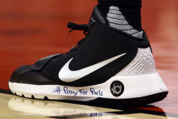 TORONTO, ON - NOVEMBER 13:  Alexis Ajinca #42 of the New Orleans Pelicans has #PrayForParis written on his shoe during an NBA game against the Toronto Raptors at the Air Canada Centre on November 13, 2015 in Toronto, Ontario, Canada.  NOTE TO USER: User expressly acknowledges and agrees that, by downloading and or using this photograph, User is consenting to the terms and conditions of the Getty Images License Agreement.  (Photo by Vaughn Ridley/Getty Images)