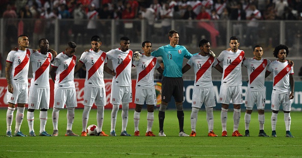 Peru's football team attend a minute of silence in honor of victims of the attacks that left at least 120 dead in Paris, France, before their Russia 2018 FIFA World Cup South American Qualifiers football match against Paraguay, in Lima, on November 12, 2015.  AFP PHOTO / CRIS BOURONCLE        (Photo credit should read CRIS BOURONCLE/AFP/Getty Images)