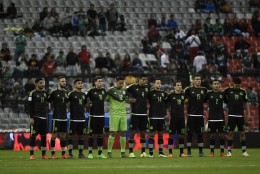 Players of Mexico stand at attention during the minute silence for the victims of the Paris attacks before the start of their Russia 2018 FIFA World Cup South American Qualifiers football against Salvador, in Mexico City, on November 13, 2015. AFP PHOTO / ALFREDO ESTRELLA        (Photo credit should read ALFREDO ESTRELLA/AFP/Getty Images)