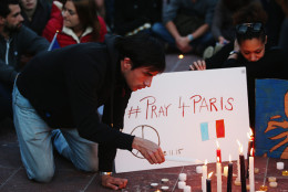 AUCKLAND, NEW ZEALAND - NOVEMBER 14: A man lights a candle during a vigil in Aotea Square to remember victims of the Paris attacks on November 14, 2015 in Auckland, New Zealand. According to reports, over 150 people were killed in a series of bombings and shootings across Paris, including at a soccer game at the Stade de France and a concert at the Bataclan theater.  (Photo by Hannah Peters/Getty Images)