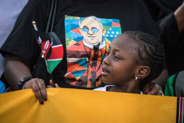 NAIROBI, KENYA - NOVEMBER 25:  A young girl waits on the roadside for Pope Francis' convoy to drive through the capital from the airport on November 25, 2015 in Nairobi, Kenya. Pope Francis makes his first visit to Kenya on a five day African tour that is scheduled to include Uganda and the Central African Republic. Africa is recognised as being crucial to the future of the Catholic Church with the continent's Catholic numbers growing faster than anywhere else in the world.  (Photo by Nichole Sobecki/Getty Images)