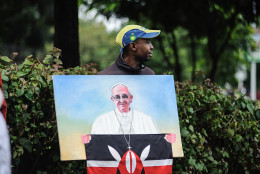 A man hold a picture of Pope Francis during a mass at the University of Nairobi on November 26, 2015 in Nairobi. Pope Francis held his first open-air mass in Africa on November 26 with huge crowds calling heavy rains "God's blessing" as they sung and danced in the Kenyan capital.Thousands of people queued throughout the night braving torrential rains to secure a place at the first mass celebrated by Francis on African soil.
AFP PHOTO/JENNIFER HUXTA / AFP / Jennifer Huxta        (Photo credit should read JENNIFER HUXTA/AFP/Getty Images)
