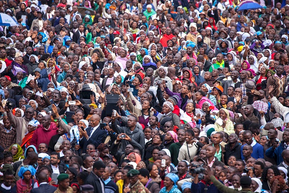 People gather at the University of Nairobi to attend a giant open-air mass celebrated by Pope Francis on November 26, 2015. Pope Francis held his first open-air mass in Africa on November 26 with huge crowds calling heavy rains "God's blessing" as they sung and danced in the Kenyan capital. The 78-year-old pontiff, the third pope to visit the continent, is also scheduled to visit Uganda and the troubled Central African Republic (CAR) on a six-day trip.  AFP PHOTO/GEORGINA GOODWIN / AFP / Georgina Goodwin        (Photo credit should read GEORGINA GOODWIN/AFP/Getty Images)
