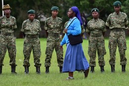 A nun walks past security personnel as she arrives for a meeting attended by the pope at St Mary School in Nairobi on November 26, 2015. Pope Francis landed in Kenya's capital Nairobi on November 25 on the first leg of a landmark trip to Africa, with huge crowds, choirs and dancers waiting to greet him. The 78-year-old pontiff, the third pope to visit the continent, is also scheduled to visit Uganda and the troubled Central African Republic (CAR) on a six-day trip. AFP PHOTO / GIUSEPPE CACACE / AFP / GIUSEPPE CACACE        (Photo credit should read GIUSEPPE CACACE/AFP/Getty Images)