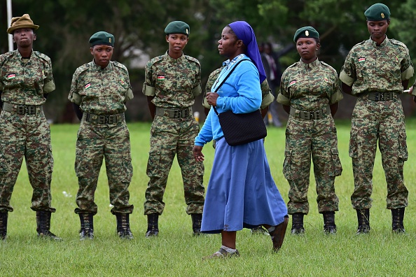 A nun walks past security personnel as she arrives for a meeting attended by the pope at St Mary School in Nairobi on November 26, 2015. Pope Francis landed in Kenya's capital Nairobi on November 25 on the first leg of a landmark trip to Africa, with huge crowds, choirs and dancers waiting to greet him. The 78-year-old pontiff, the third pope to visit the continent, is also scheduled to visit Uganda and the troubled Central African Republic (CAR) on a six-day trip. AFP PHOTO / GIUSEPPE CACACE / AFP / GIUSEPPE CACACE        (Photo credit should read GIUSEPPE CACACE/AFP/Getty Images)