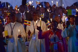 People attend a visit by Pope Francis with the Munyonyo community on November 27, 2015 in Kampala. Pope Francis arrived in Uganda on November 27 on the second leg of a landmark trip to Africa which has seen him railing against corruption and poverty, with huge crowds celebrating his arrival. AFP PHOTO / GIUSEPPE CACACE / AFP / GIUSEPPE CACACE        (Photo credit should read GIUSEPPE CACACE/AFP/Getty Images)