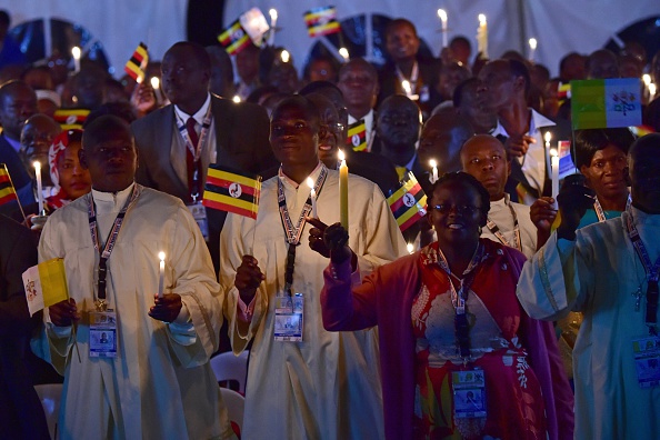 People attend a visit by Pope Francis with the Munyonyo community on November 27, 2015 in Kampala. Pope Francis arrived in Uganda on November 27 on the second leg of a landmark trip to Africa which has seen him railing against corruption and poverty, with huge crowds celebrating his arrival. AFP PHOTO / GIUSEPPE CACACE / AFP / GIUSEPPE CACACE        (Photo credit should read GIUSEPPE CACACE/AFP/Getty Images)