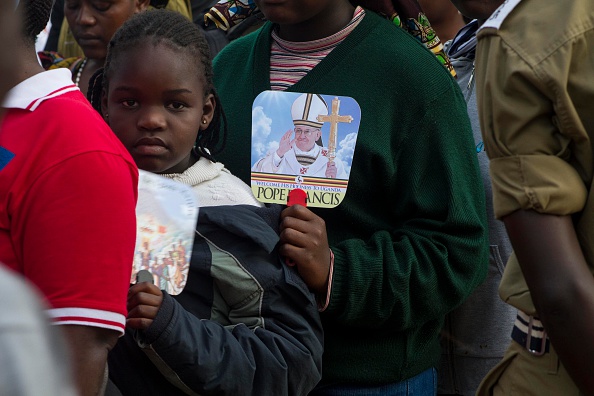 People queue in line waiting for Pope Francis at the Namugongo Catholic shrine in Namugongo on November 28, 2015, where the pontiff is slated to hold a mass. AFP PHOTO/ ISAAC KASAMANI / AFP / ISAAC KASAMANI        (Photo credit should read ISAAC KASAMANI/AFP/Getty Images)