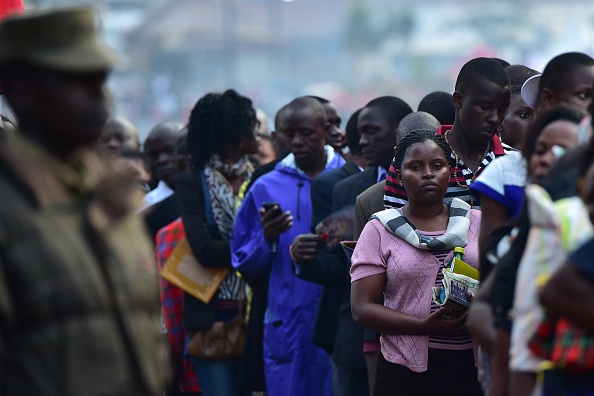 People wait for the arrival of Pope Francis for an open mass in  Kampala, Uganda, November 28, 2015. Pope Francis arrived in Uganda on November 27 on the second leg of a landmark trip to Africa which has seen him railing against corruption and poverty, with huge crowds celebrating his arrival. AFP PHOTO / GIUSEPPE CACACE / AFP / GIUSEPPE CACACE        (Photo credit should read GIUSEPPE CACACE/AFP/Getty Images)